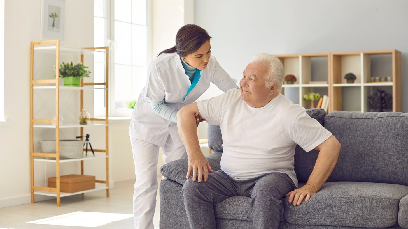A Carevana caregiver helping a senior patient at home